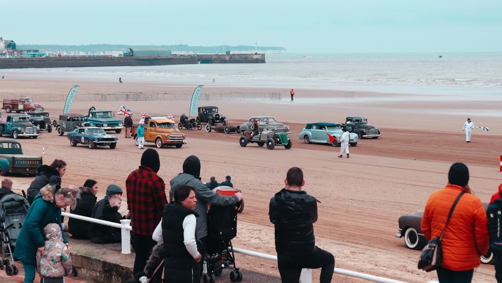 a group of people watching a race on a beach