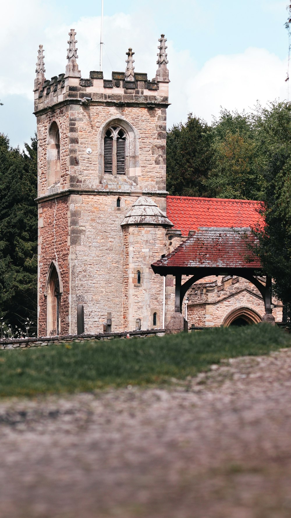 an old brick building with a red roof