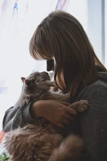 A model and their cat sharing a quiet, intimate moment during a creative photo session.