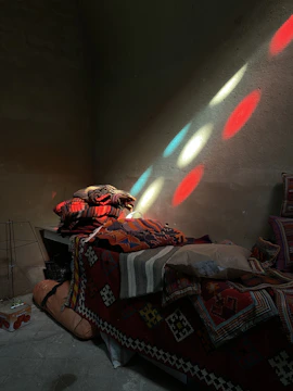 A cozy Snoezelen room softly lit with colorful lights and textured cushions.