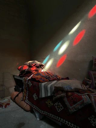 A cozy, softly lit room with cushions and blankets arranged for a group cuddle session.