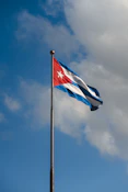 a flag flying in the wind on a cloudy day