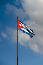 a flag flying in the wind on a cloudy day