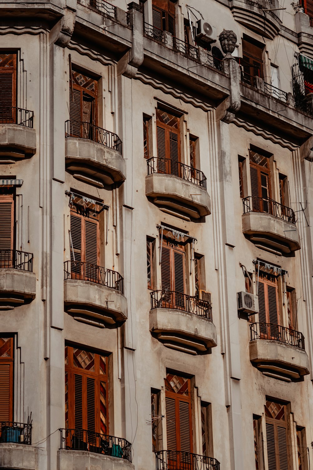 a tall building with lots of windows and balconies