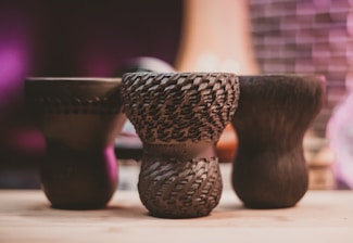 Close-up of a beautifully textured ceramic piece resting on a wooden table, evoking warmth and harmony.