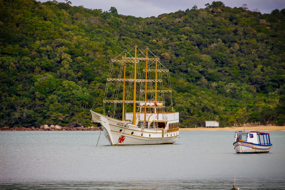 a large white boat floating on top of a lake