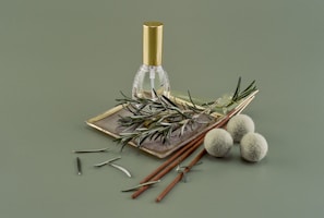 Close-up of amber-colored ayurvedic deep pain relief oil in a glass bottle with fresh herbs around.