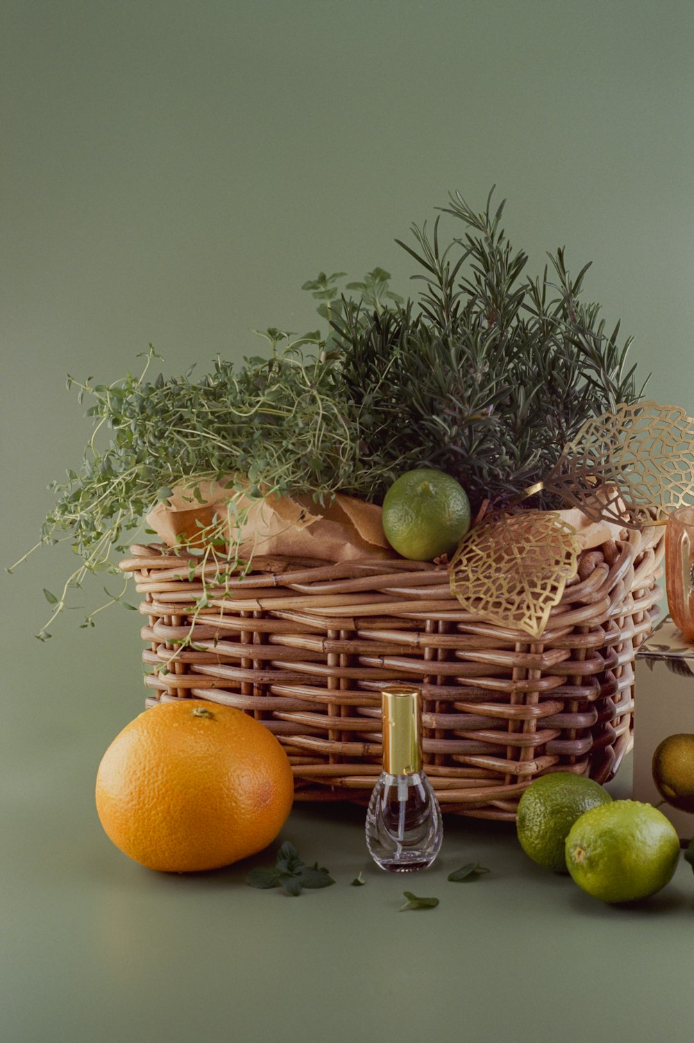 a wicker basket filled with fruit and greenery