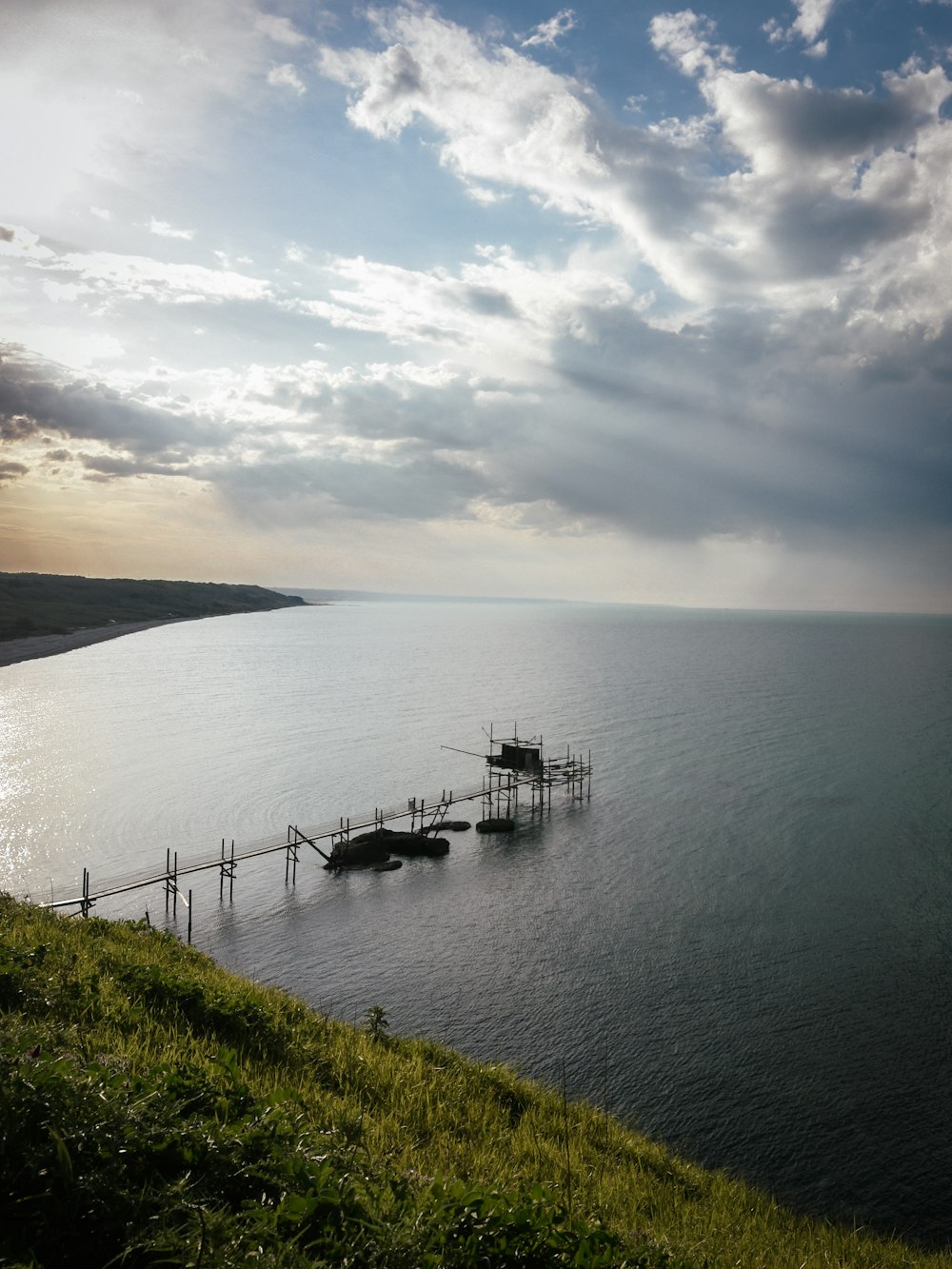 a body of water with a dock in the middle of it