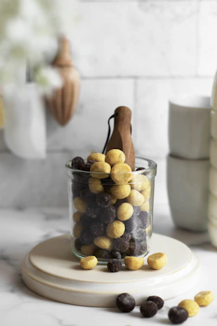 Happy customer holding a homemade cereal bar with a bright kitchen background.
