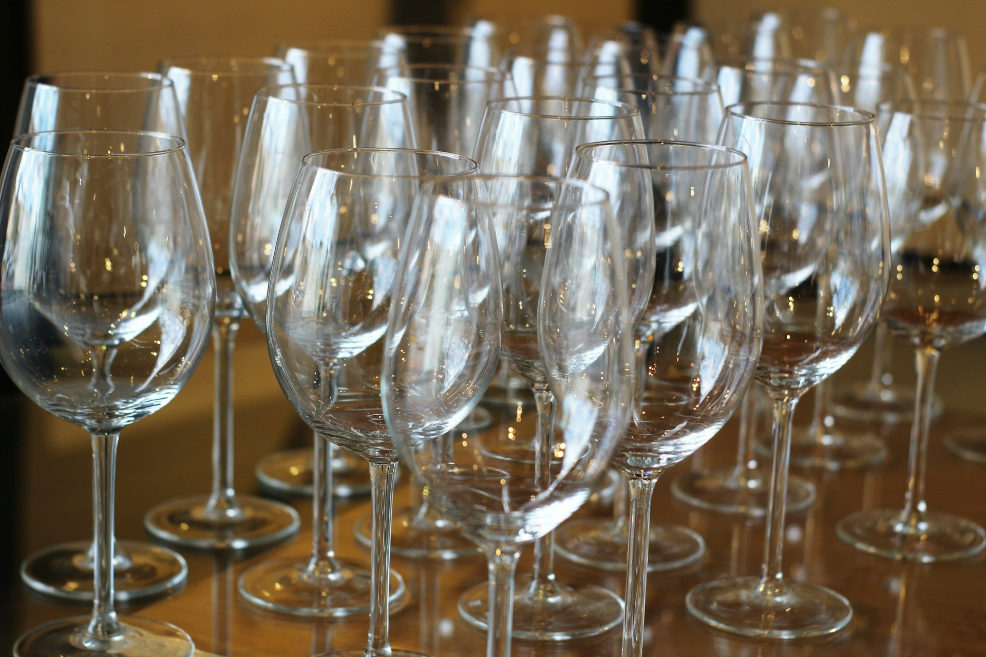 a bunch of wine glasses lined up on a table