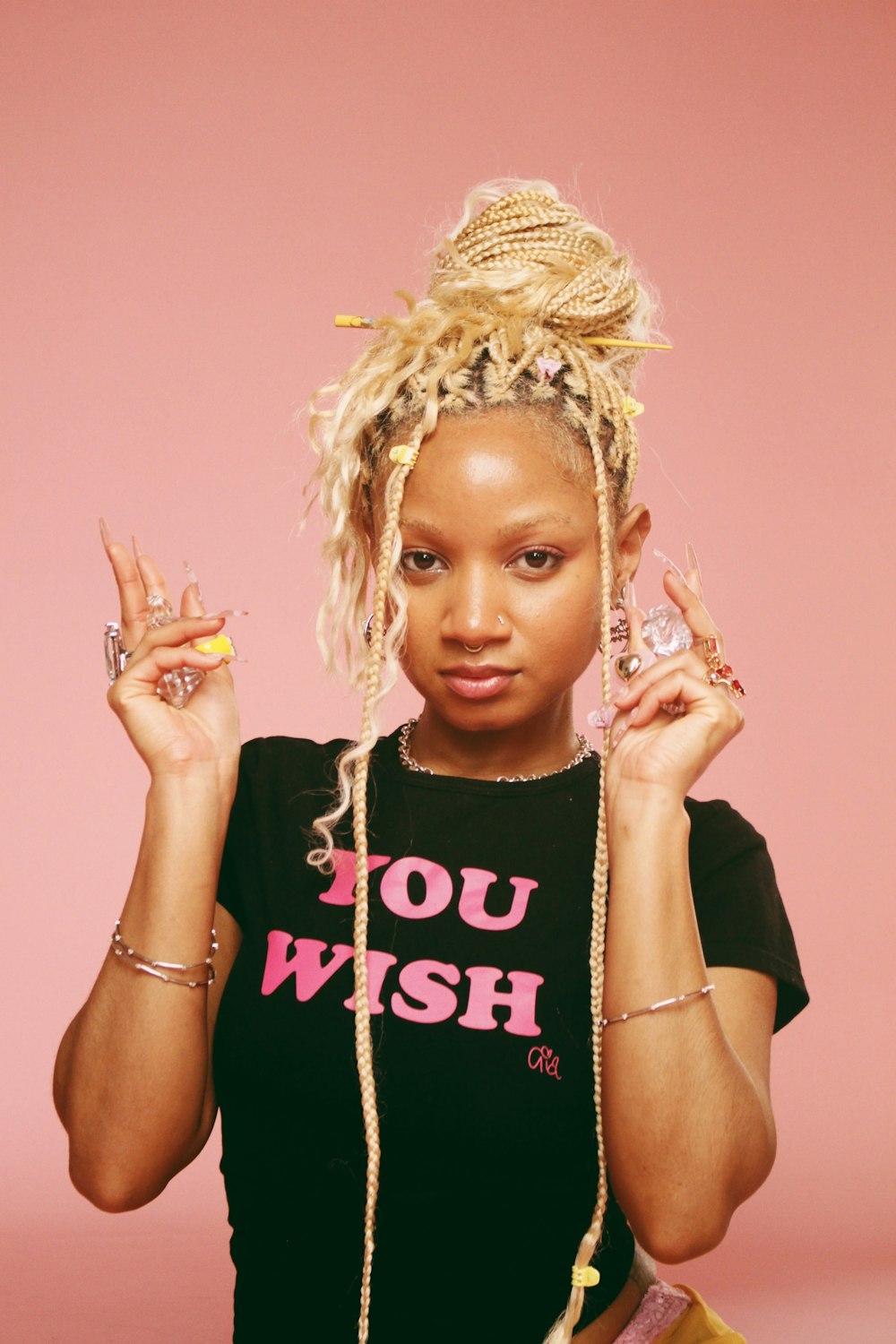 a woman with blonde dreadlocks and a black shirt