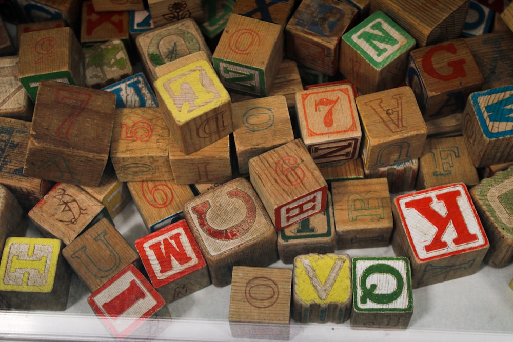 a pile of wooden blocks with letters and numbers on them