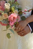 a close up of a person holding a bouquet of flowers