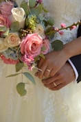 a close up of a person holding a bouquet of flowers