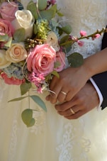 a close up of a person holding a bouquet of flowers
