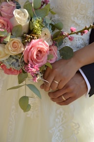a close up of a person holding a bouquet of flowers