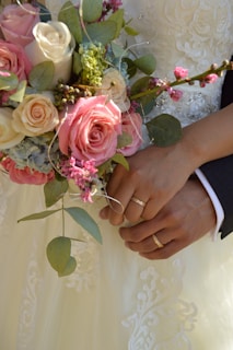 a close up of a person holding a bouquet of flowers