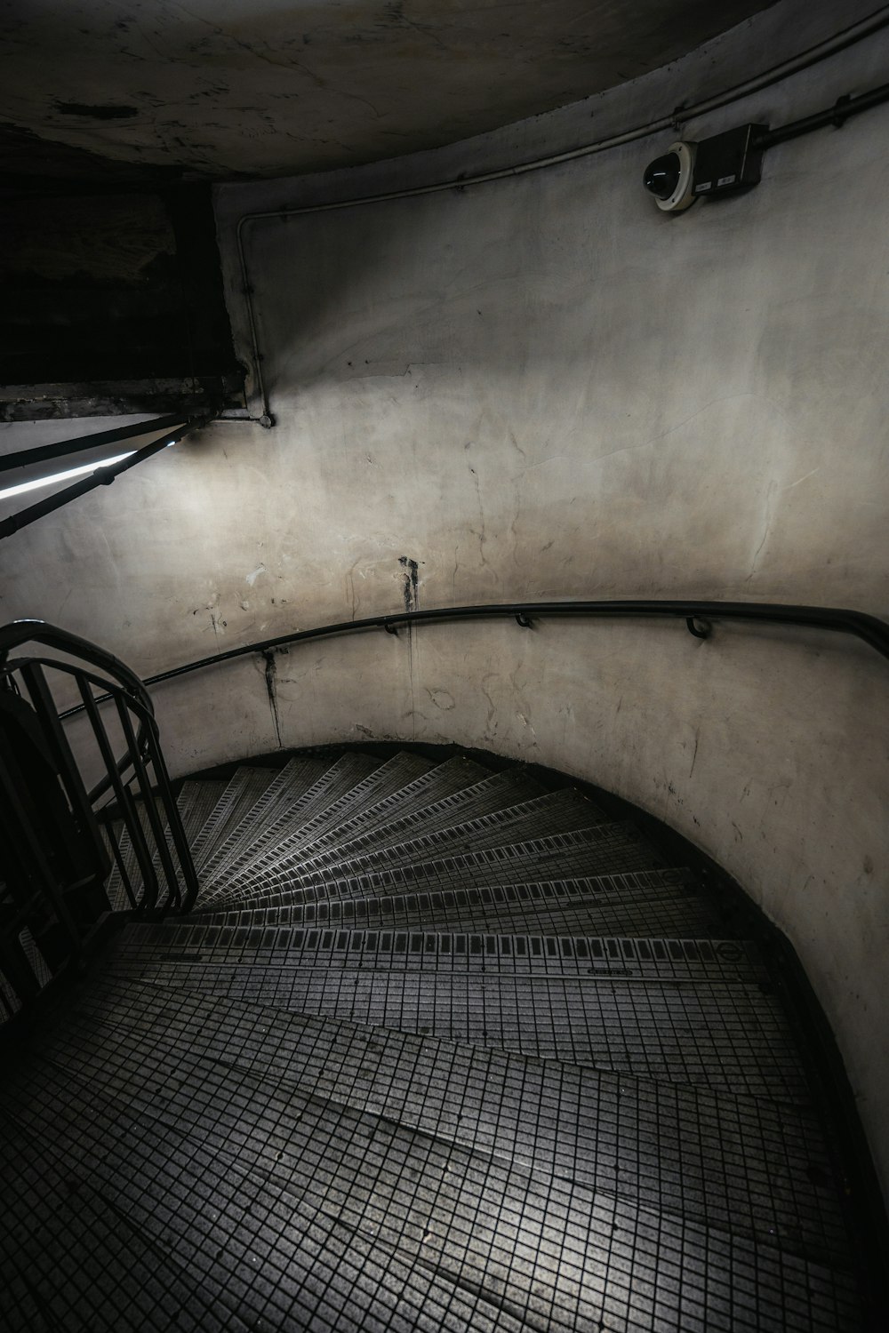 a spiral staircase in a building with a metal railing