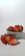 Close-up of a bowl filled with fresh strawberries topped with creamy, smooth cream.