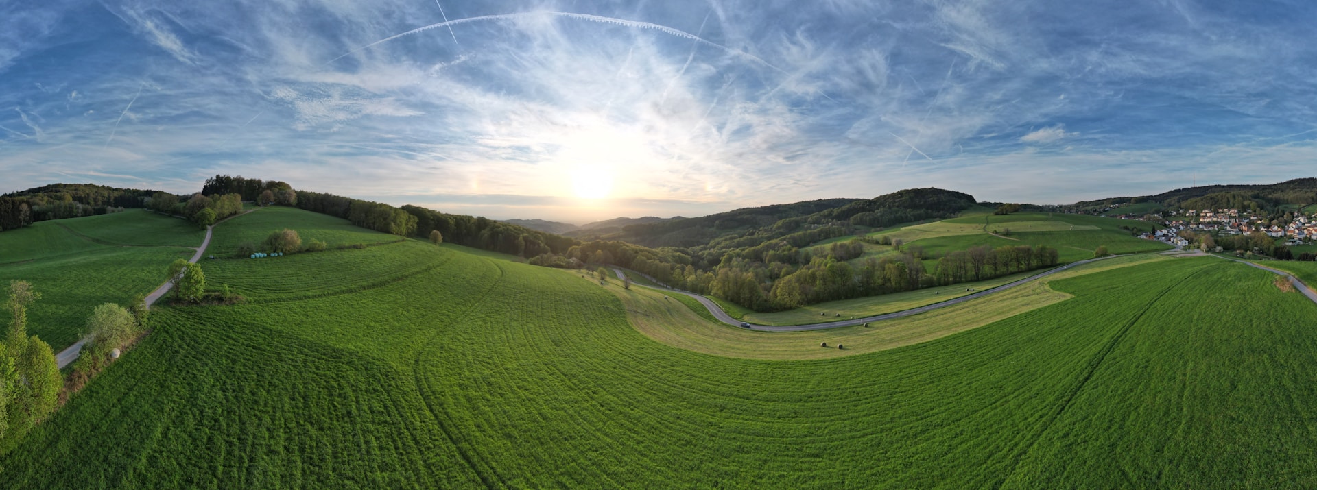A panoramic view of rolling farmland at sunrise, highlighting the natural beauty of land Keystone Land Co. acquires.