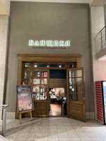 The warm and welcoming entrance of Svijet Okusa, with multilingual signs greeting visitors.