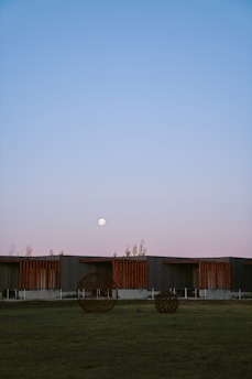 A serene view of the museum's outdoor sculpture garden at sunset.