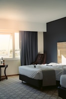 a hotel room with two beds and a chair