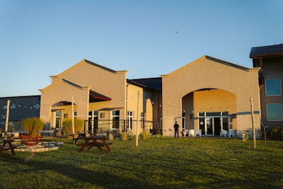 Wide shot of a community center with open spaces and inviting outdoor areas during sunset.