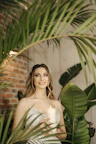 a woman in a wedding dress holding a candle