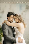 a bride and groom embracing each other