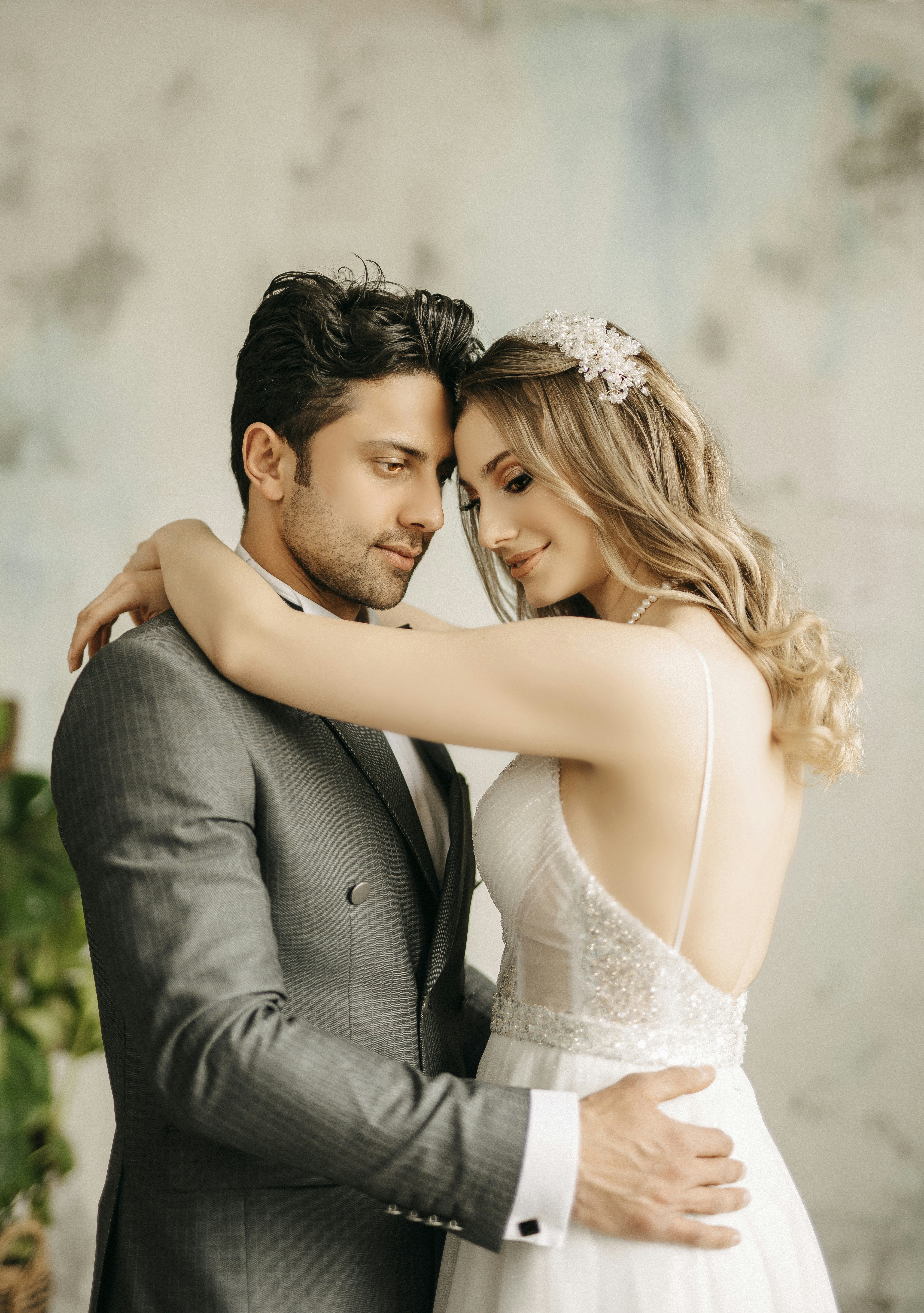 a bride and groom embracing each other