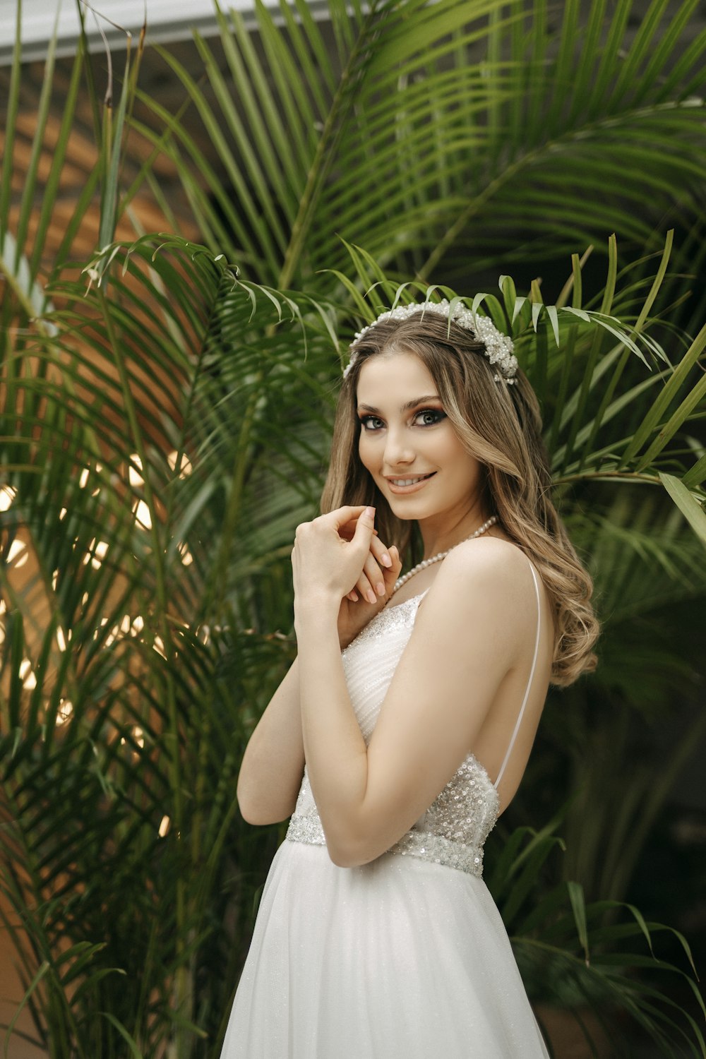 a woman in a white dress posing for a picture