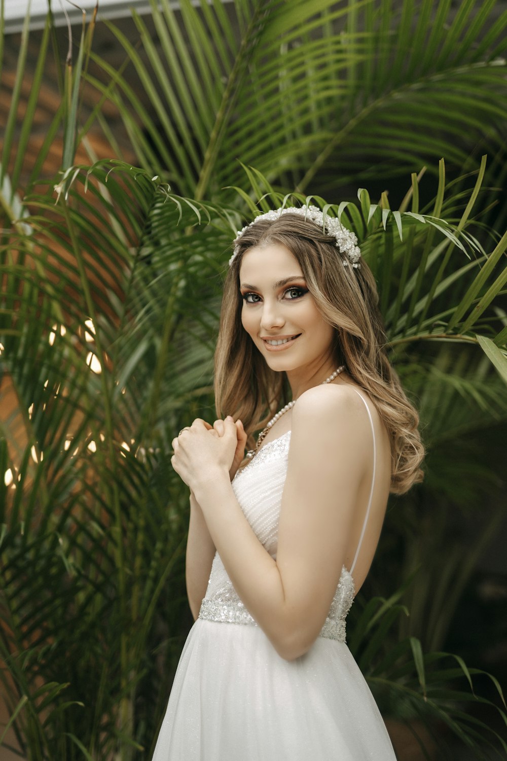 a woman in a white dress posing for a picture