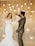 A couple dancing under soft, ambient lighting at their wedding reception.