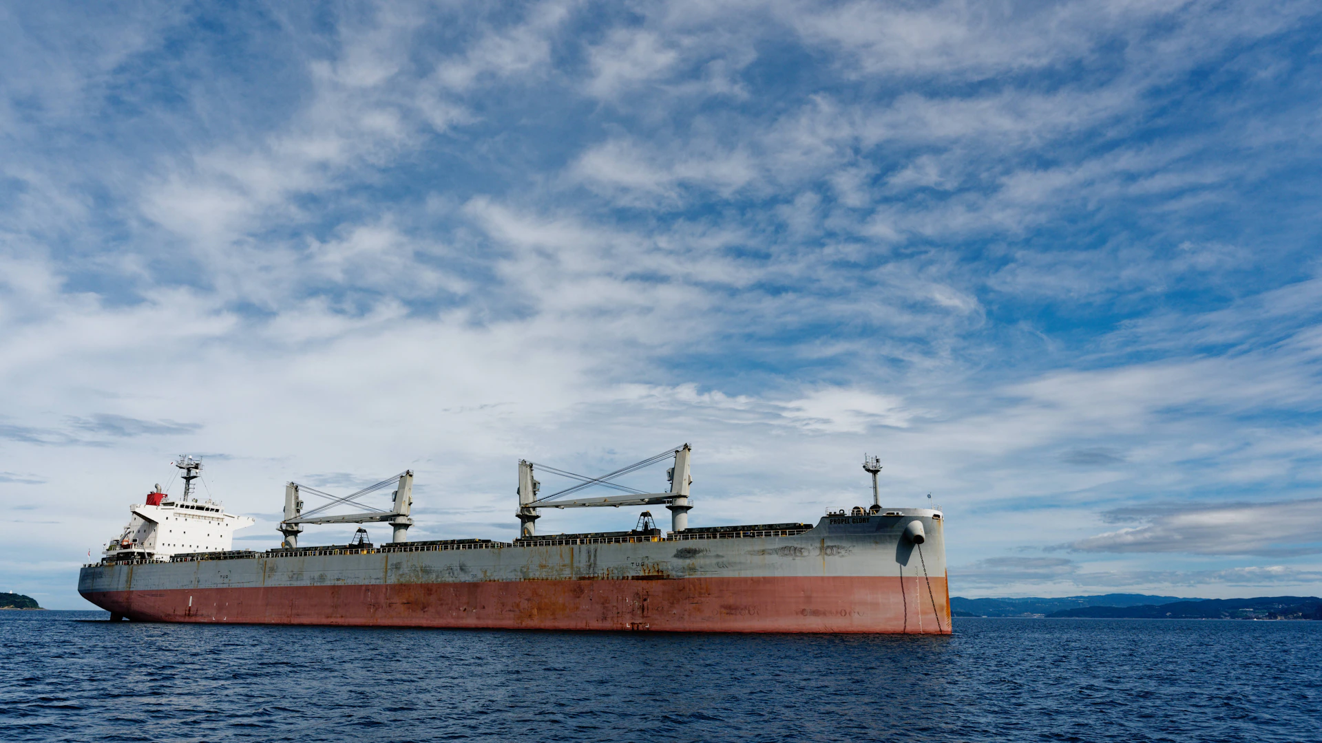 a large cargo ship floating on top of a body of water