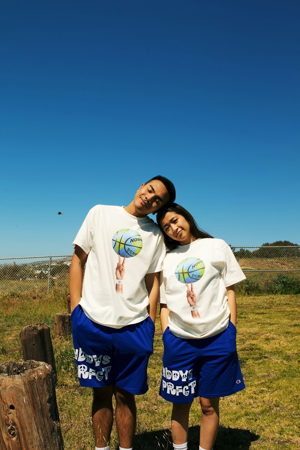 a couple of people that are standing in the grass