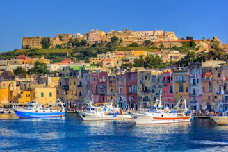 a number of boats in a body of water near a city