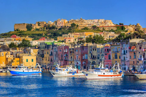 a number of boats in a body of water near a city