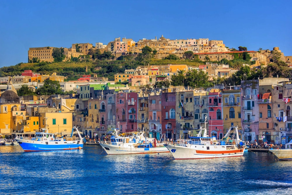 a number of boats in a body of water near a city