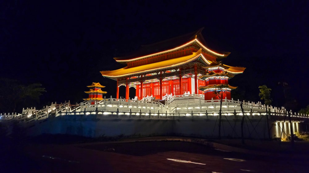 a building lit up at night with lights on it