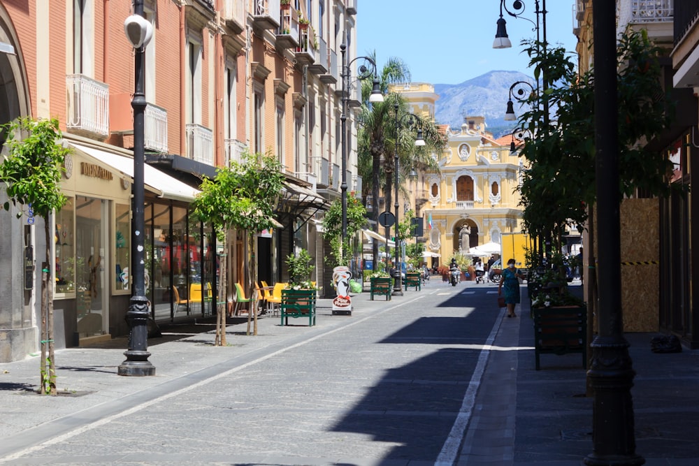 a city street lined with tall buildings and palm trees