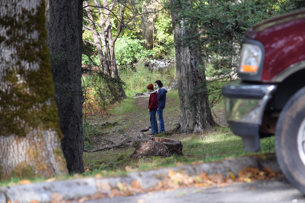 a couple of people standing in the woods