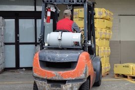 a man driving a forklift in a warehouse