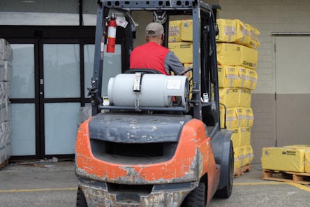 a man driving a forklift in a warehouse