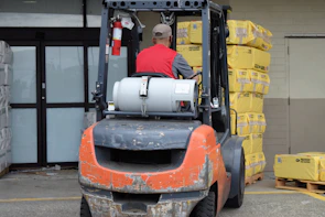 Experienced male technician performing maintenance on a combustion forklift