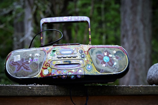 A portable satellite radio receiver being used outdoors on a hiking trail.