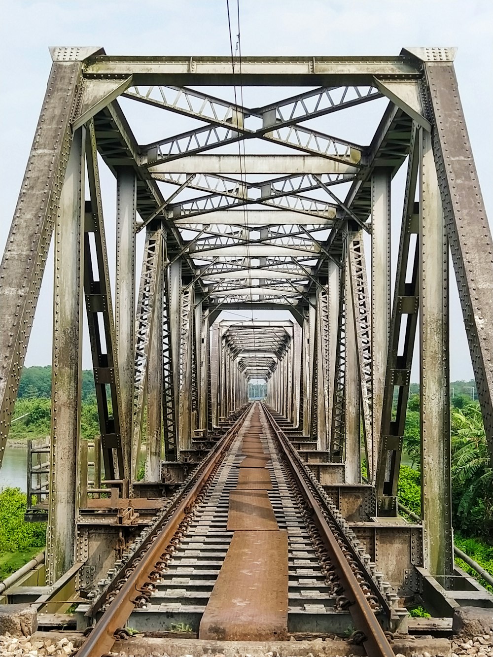 a train track going across a bridge over water