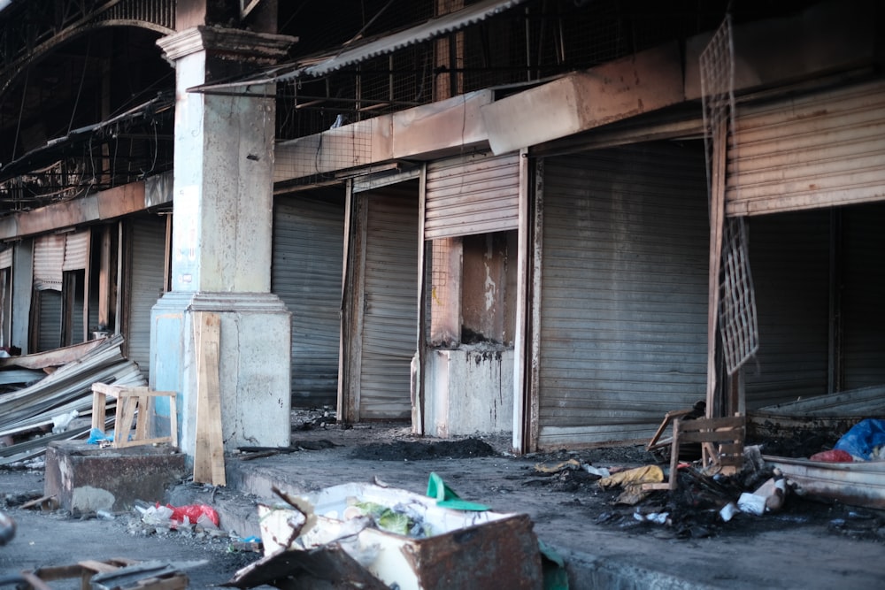 a run down building with lots of trash on the ground