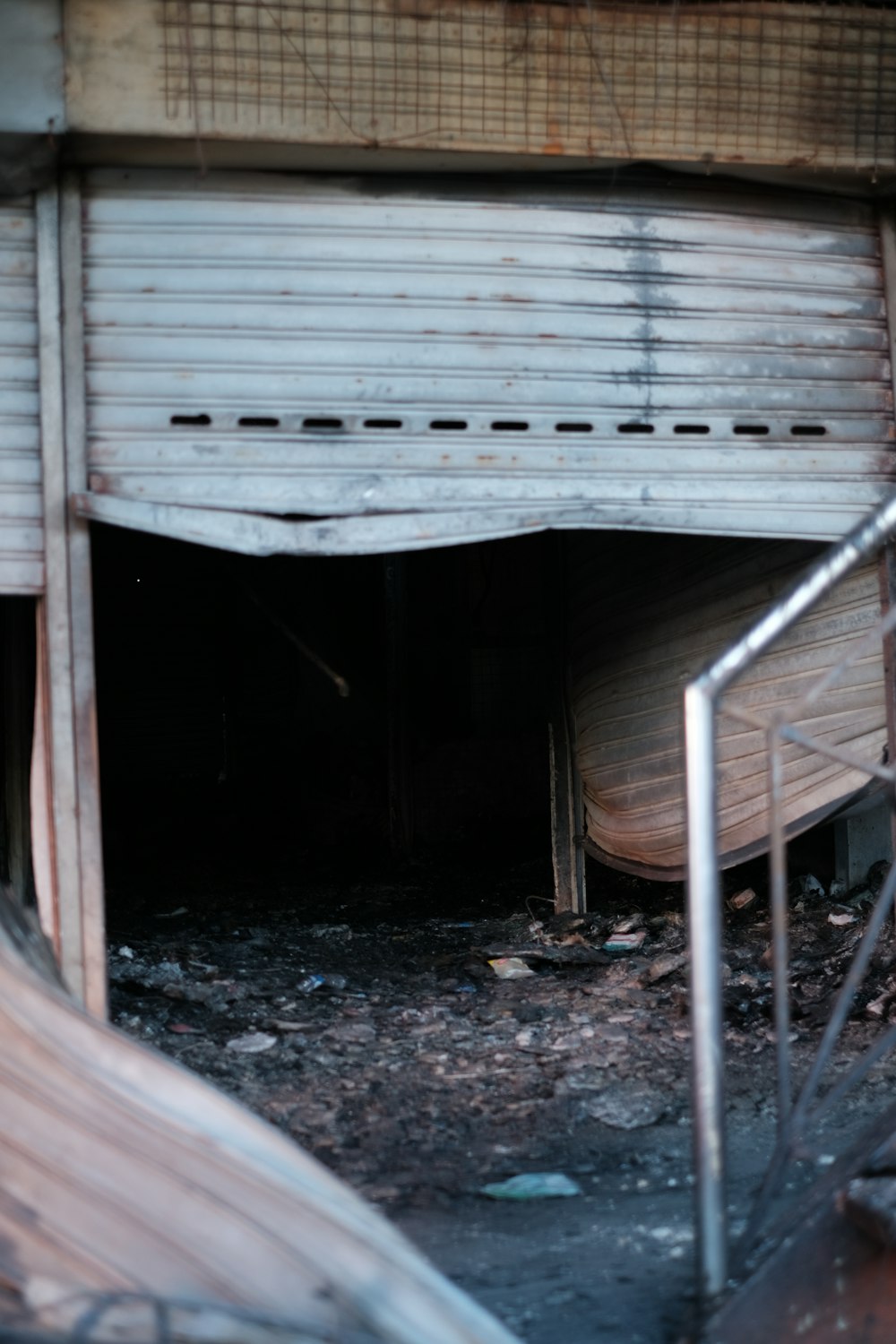 a run down building with a staircase going up to it